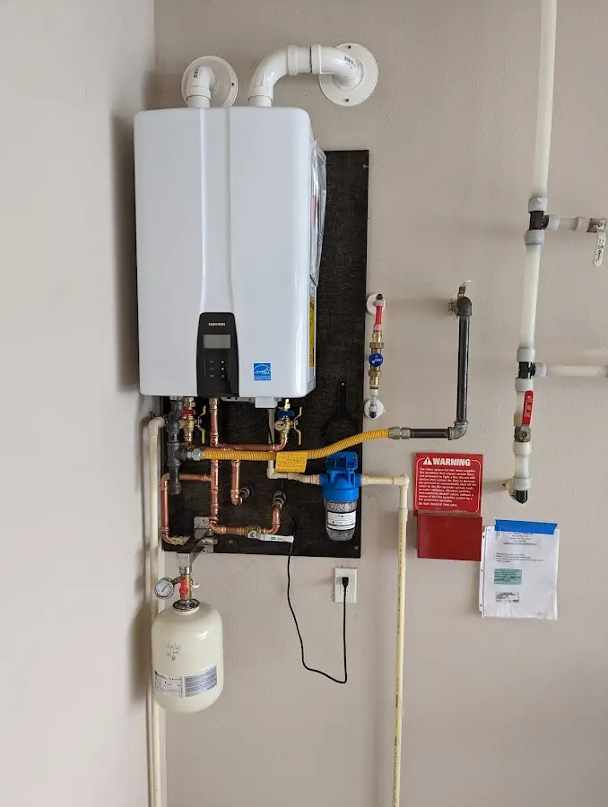 Professional plumber installing copper piping in a Germantown home